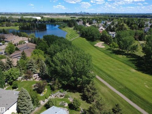 Aerial perspective showcasing a residential area bordered by a body of water and a golf course - 915 Picard Drive Nw, Edmonton, AB 