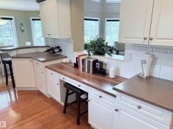 Custom built-in desk area featuring wood-finish countertop - 
