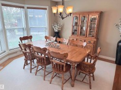 Dining area featuring a prominent bay window, neutral wall tones, and recessed lighting - 