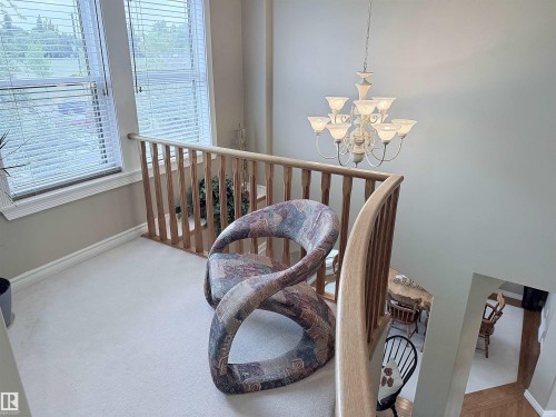 Upper level featuring light-toned carpeting and wood balusters - 915 Picard Drive Nw, Edmonton, AB 