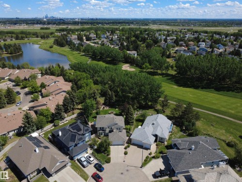 Aerial perspective showcasing a residential community bordering a lake and golf course - 915 Picard Drive Nw, Edmonton, AB 