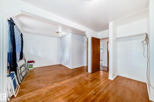 Interior space featuring wood-finish flooring, white walls, and a recessed ceiling light - 6804 102A Avenue, Edmonton, AB 