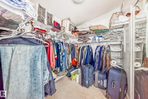 Custom closet organization system featuring wire shelving and multiple hanging rods - 6804 102A Avenue, Edmonton, AB 