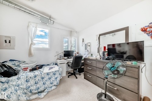 White walls and light-colored carpeting create a bright interior - 6804 102A Avenue, Edmonton, AB 