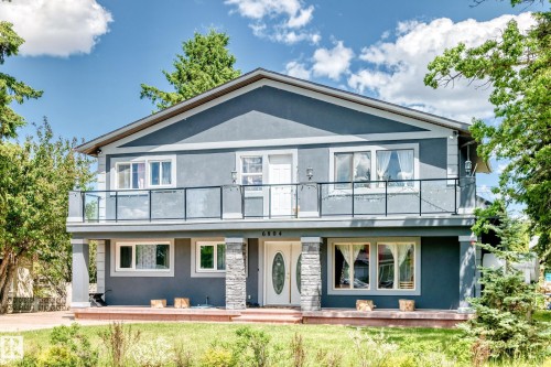 Two-story residence featuring a stucco exterior with stone accents - 6804 102A Avenue, Edmonton, AB 