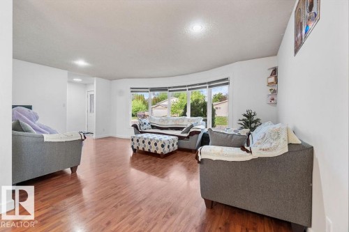 Spacious living area featuring wood-finish flooring, recessed lighting, and a bay window - 712 Lee Ridge Road, Edmonton, AB 