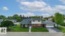 Split-level residence featuring brick and siding facade, an attached two-car garage, and a concrete driveway - 712 Lee Ridge Road, Edmonton, AB 