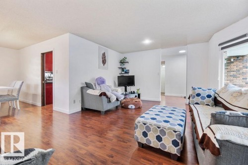Bright living area featuring wood-finish flooring and white painted walls - 712 Lee Ridge Road, Edmonton, AB 
