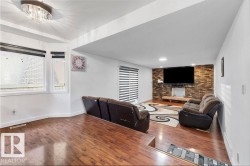 Multi-level living area featuring rich wood-finish flooring - 
