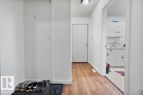 Entryway with wood-finish flooring and a white paneled door - 712 Lee Ridge Road, Edmonton, AB 