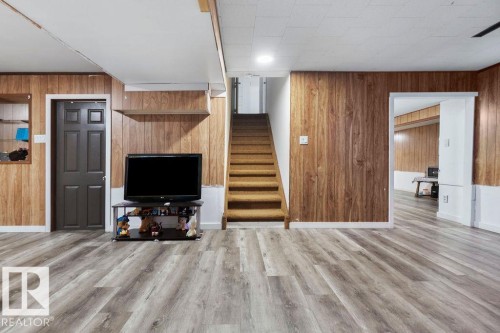 Finished lower level featuring wood-finish flooring, wood paneling, and a neutral color palette - 712 Lee Ridge Road, Edmonton, AB 