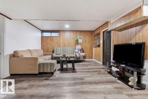 Recreation room featuring wood-finish flooring, wood paneling, and recessed lighting - 712 Lee Ridge Road, Edmonton, AB 
