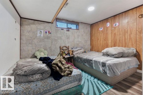 Room featuring wood-finish flooring, recessed lighting, and a window providing natural light - 712 Lee Ridge Road, Edmonton, AB 