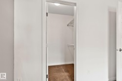 Walk-in closet with wire shelving system and carpet flooring - 