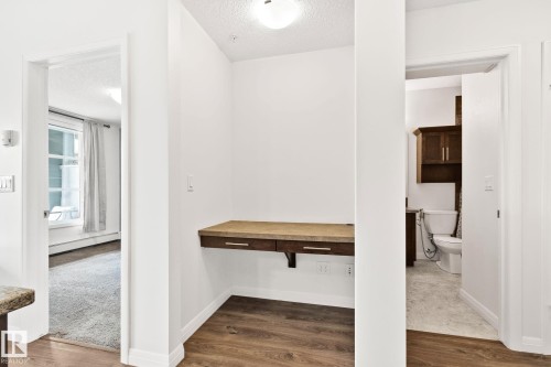 Integrated desk nook featuring a wood-finish countertop and drawer - 217 2588 Anderson Way, Edmonton, AB 