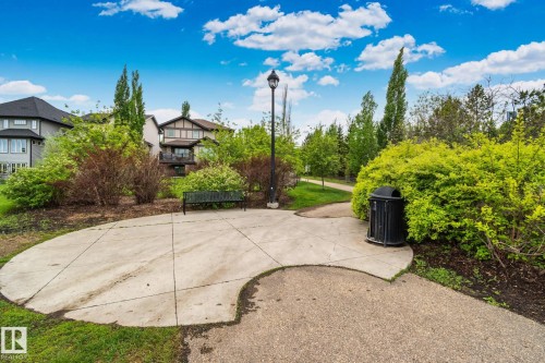 Landscaped property perimeter featuring mature trees and established greenery - 217 2588 Anderson Way, Edmonton, AB 