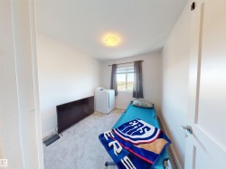 Carpeted room with white walls, a single window, and a flush-mount ceiling light fixture - 