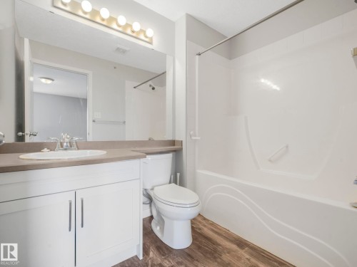 Bathroom featuring a white vanity with brushed nickel hardware, a neutral countertop, and a single basin sink - 2406 320 Clareview Station Drive, Edmonton, AB 