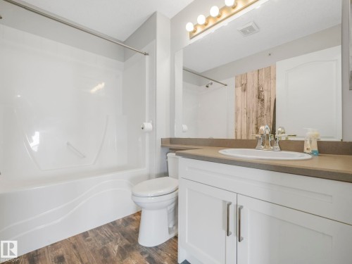 Bathroom featuring a white vanity with a rectangular undermount sink, a neutral countertop, and brushed nickel fixtures - 2406 320 Clareview Station Drive, Edmonton, AB 