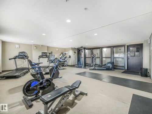 Fitness room with carpet flooring, recessed lighting, and a variety of exercise equipment - 2406 320 Clareview Station Drive, Edmonton, AB 