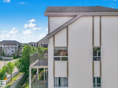 Multi-story building exterior featuring horizontal siding and dark-trimmed windows - 2406 320 Clareview Station Drive, Edmonton, AB 