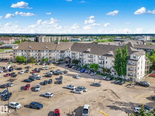 Multi-story residential building with light-colored siding and a dark shingle roof - 2406 320 Clareview Station Drive, Edmonton, AB 