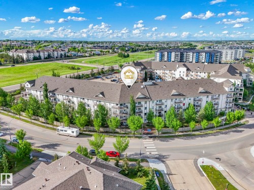 Multi-story residential building featuring balconies, dark shingle roofing, and numerous windows - 2406 320 Clareview Station Drive, Edmonton, AB 