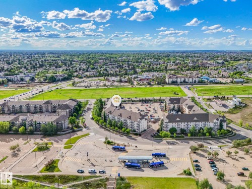 Aerial perspective showcasing a multi-story apartment complex with extensive surface parking - 2406 320 Clareview Station Drive, Edmonton, AB 