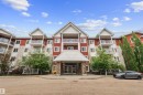 Multi-story building featuring red and cream siding with white trim - 210 2229 44 Avenue, Edmonton, AB 