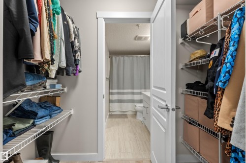 Walk-in closet featuring wire shelving storage and hanging rods - 210 2229 44 Avenue, Edmonton, AB 