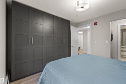 Expansive built-in wardrobe featuring contemporary panel doors and brushed nickel hardware - 