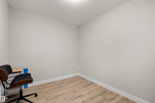 Neutral-toned walls complement the wood-finish flooring - 210 2229 44 Avenue, Edmonton, AB 