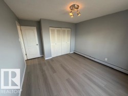 Light gray walls complement the wood-finish flooring in this room - 