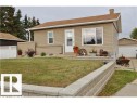 Single-story residence featuring tan siding and a brown shingle roof - 9815 160 Street, Edmonton, AB 