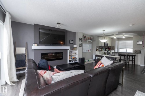 Open-concept living space featuring wood-finish flooring - 46 4050 Savaryn Drive, Edmonton, AB 