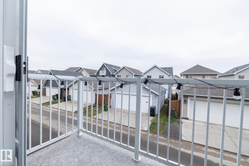 Outdoor balcony with concrete flooring and white metal railings - 46 4050 Savaryn Drive, Edmonton, AB 