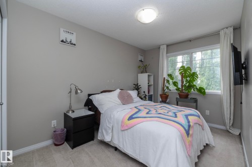 Bedroom featuring neutral grey walls and light-colored carpeting - 46 4050 Savaryn Drive, Edmonton, AB 