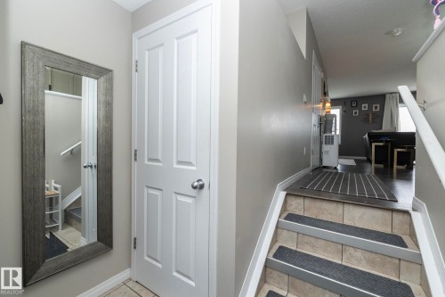 Interior entry space featuring a paneled door with a brushed nickel knob - 46 4050 Savaryn Drive, Edmonton, AB 