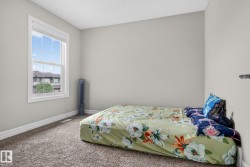 Carpeted room featuring a double-hung window with white trim, light gray walls, and white baseboards - 