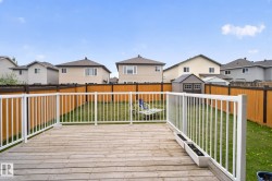 Expansive wooden deck with white railings - 