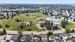 Aerial perspective of a residential neighborhood featuring detached homes with varied rooflines - 