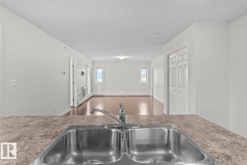 Stainless steel double basin sink with a chrome faucet - 1302-1601 8 Avenue, Cold Lake, AB 