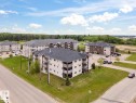 Contemporary multi-unit residential buildings featuring dark shingle roofing, light-toned siding, and private balconies - 1302-1601 8 Avenue, Cold Lake, AB 