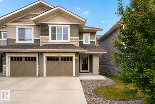 Two-story exterior with multi-toned siding, twin garage doors, and a concrete driveway - 3806 Powell Wynd, Edmonton, AB 