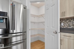 Walk-in pantry with white wire shelving and wood-finish flooring - 