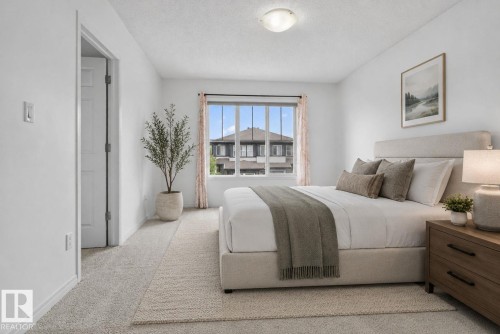 Carpeted room featuring a double-paned window, neutral wall paint, and a flush-mount ceiling light fixture - 3806 Powell Wynd, Edmonton, AB 