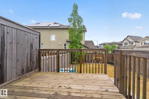 Wood-finish deck with railing, providing outdoor living space - 3806 Powell Wynd, Edmonton, AB 