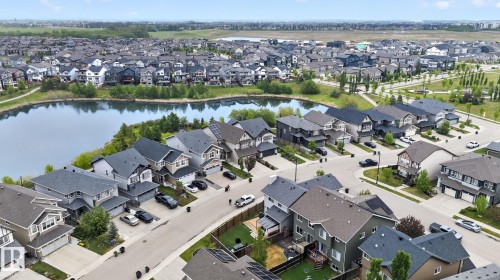 Aerial perspective of a residential neighborhood featuring a central lake - 3806 Powell Wynd, Edmonton, AB 