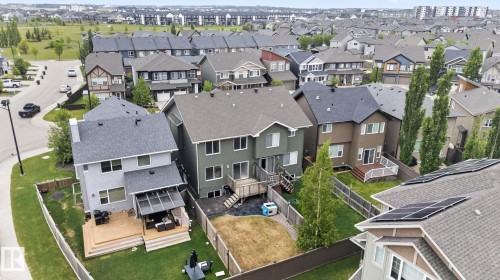 Rear facade featuring an elevated wood deck with covered patio area - 3806 Powell Wynd, Edmonton, AB 