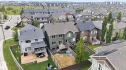 Rear facade featuring an elevated wood deck with covered patio area - 